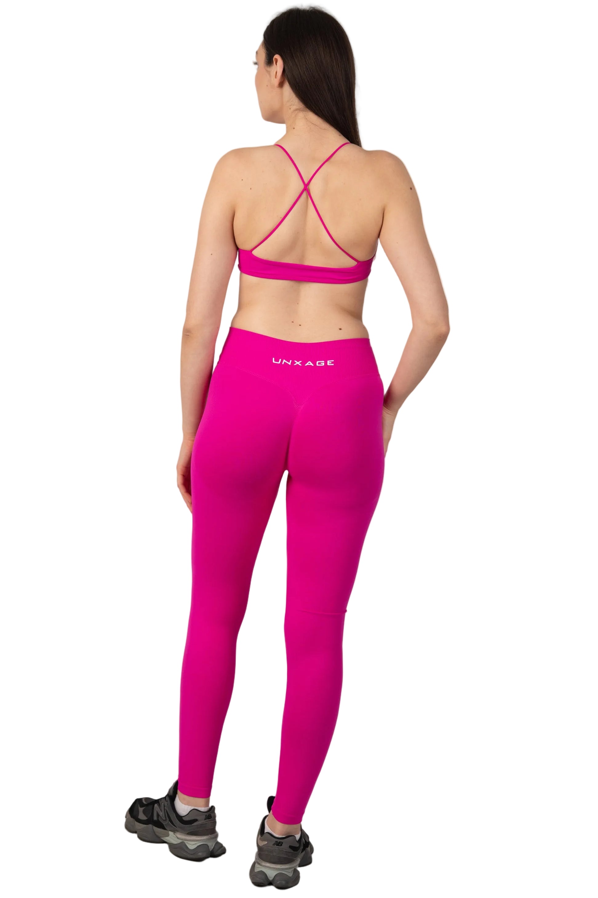Person wearing a bright pink athletic outfit with 'Vilole' branding on a light gray background